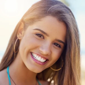 Smiling woman showing bright white teeth, representing results from teeth whitening in Stuart for a more confident smile